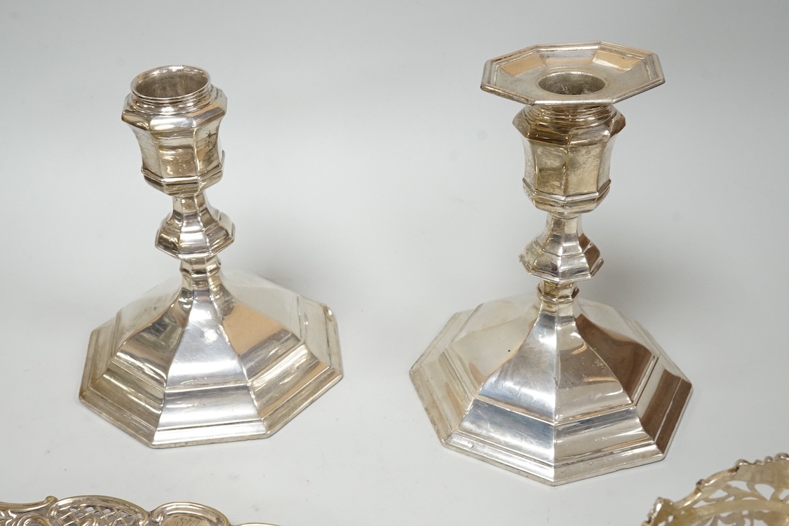 A pair of Edwardian silver mounted octagonal dwarf candlesticks by William Hutton & Sons, London, 1905, 12.7cm, weighted, one lacking sconce, together with a silver pin tray a continental sugar bowl with glass liner and